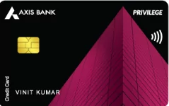 The image shows a credit card from Axis Bank. It has a black background with a prominent magenta geometric design resembling a building. The card features a gold chip on the left side and the words "PRIVILEGE" and "VINIT KUMAR" on the right. The contactless payment symbol is also visible.