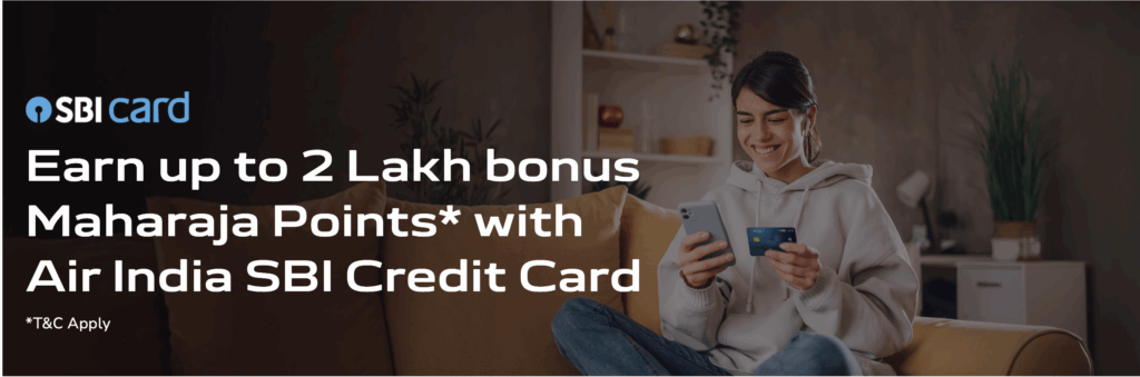 a man sitting on a couch holding a phone and credit card