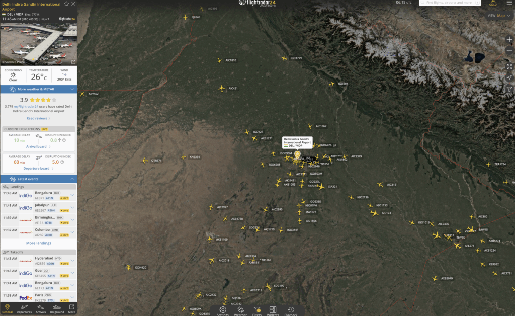 The image is a screenshot from a flight tracking application showing the air traffic around Delhi Indira Gandhi International Airport. It displays numerous yellow airplane icons representing flights in the region. The map includes geographical features and borders, with a focus on the northern part of India. On the left side, there is a panel providing details about the airport, including current weather conditions, temperature, wind speed, and user ratings. It also lists recent landings and takeoffs with airline names and flight numbers.