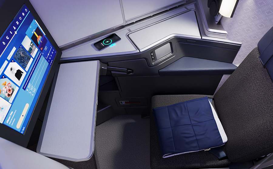 a seat with a screen and a pillow on the side