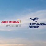 The image features the logos of Air India and Lufthansa Group against a background of a blue sky with some clouds. The Air India logo includes the text "AIR INDIA" in red with a gold design element and "STAR ALLIANCE" below it. The Lufthansa Group logo includes a stylized bird and the text "LUFTHANSA GROUP" in blue.