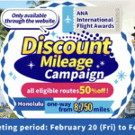 The image is an advertisement for the ANA International Flight Awards' "Discount Mileage Campaign." It features a central graphic with text offering "all eligible routes 50% off" and "Honolulu one-way from 8,750 miles." The background includes various travel destination images, such as beaches with palm trees, a traditional Asian temple, a city skyline, and futuristic structures. The bottom text indicates the reservation and ticketing period from February 20 to February 28, 2026.