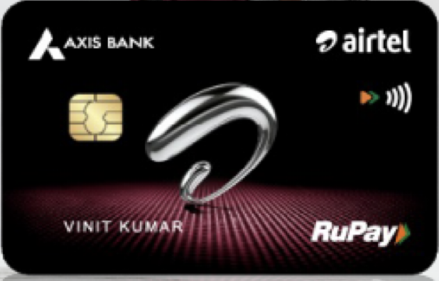 This image shows a black credit card with the logos of Axis Bank and Airtel. It features a silver abstract design in the center, a chip on the left side, and the RuPay logo on the bottom right. The card also has contactless payment symbols and a name printed on it.